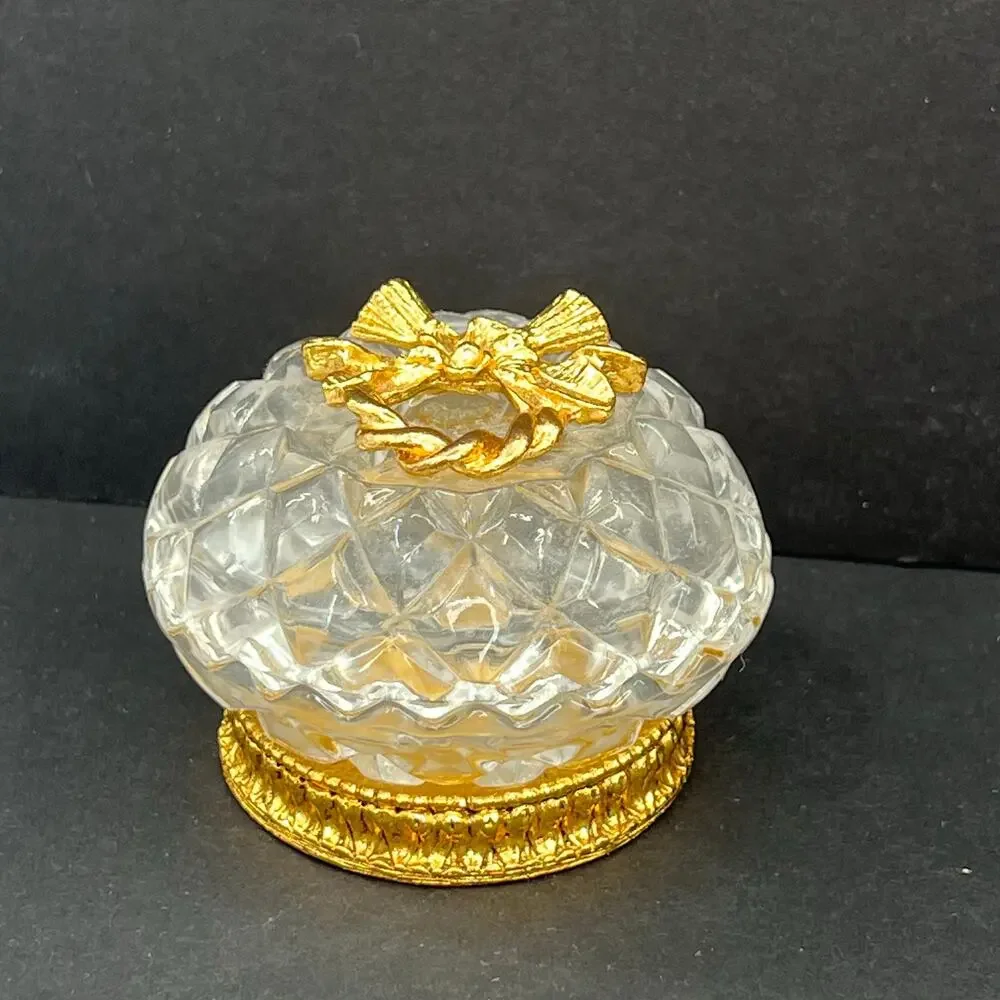 Stylebuilt trinket box, 24K gold plated and a crystal or glass top.